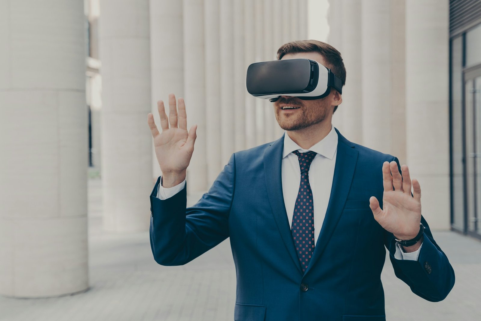 Surprised male office worker dressed formally stands outdoors in 3d goggles